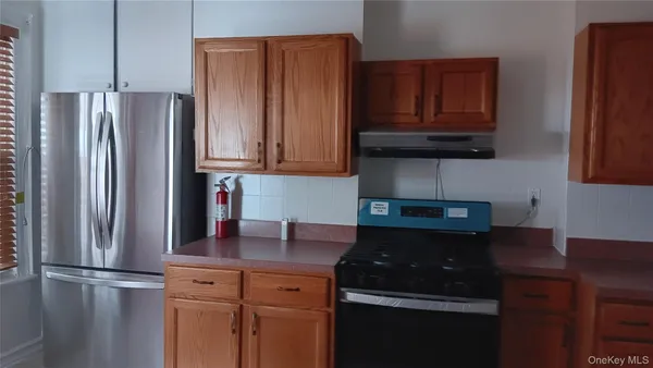 a kitchen with stainless steel appliances granite countertop a refrigerator and a stove top oven