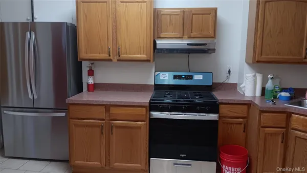 a kitchen with stainless steel appliances granite countertop a stove and a refrigerator