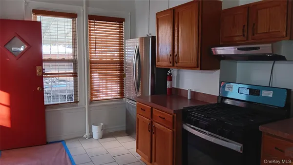 a kitchen with granite countertop a refrigerator and a stove