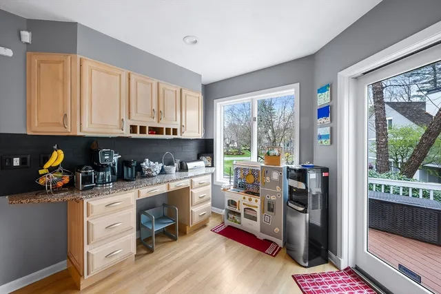 a kitchen with a refrigerator a stove top oven and a window