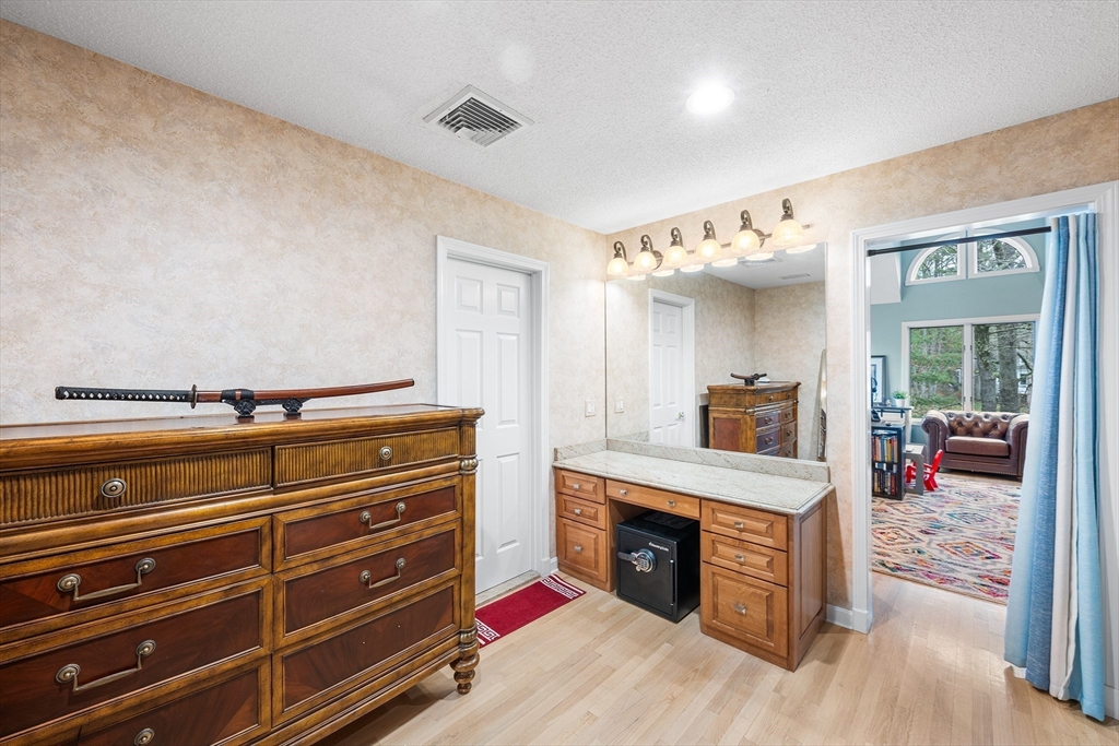 3 Choate Lane Ipswich, MA 01938 - Photo 16 of 39 a spacious bedroom with a bed and a fireplace
