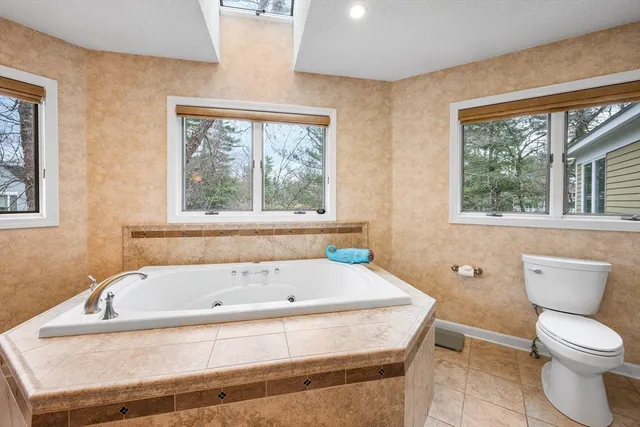 a bathroom with a granite countertop sink and a bathtub