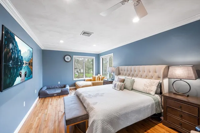 a bedroom with bed and wooden floor