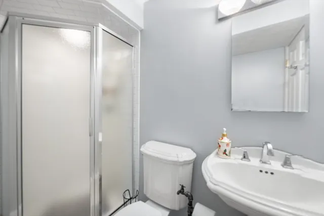 a bathroom with a sink toilet and shower