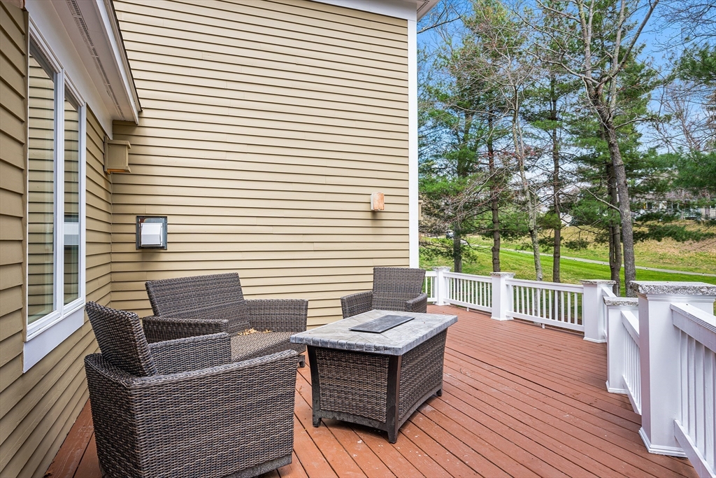 3 Choate Lane Ipswich, MA 01938 - Photo 34 of 39 a view of a deck with couches table and chairs and wooden floor