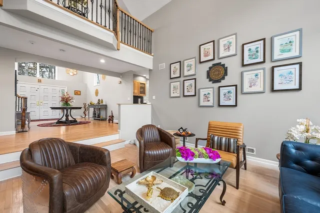 a living room with furniture and paintings on the wall