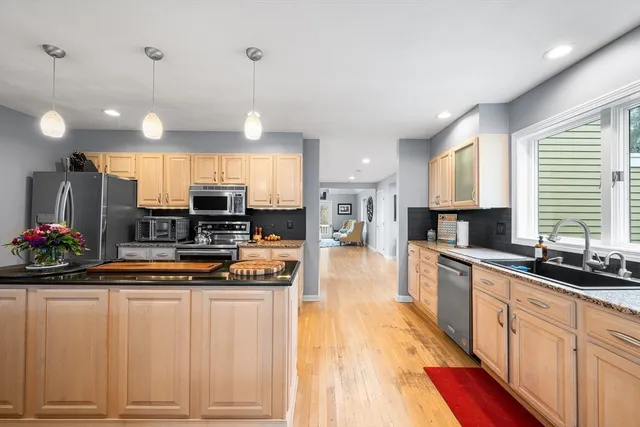 a kitchen with white cabinets and sink