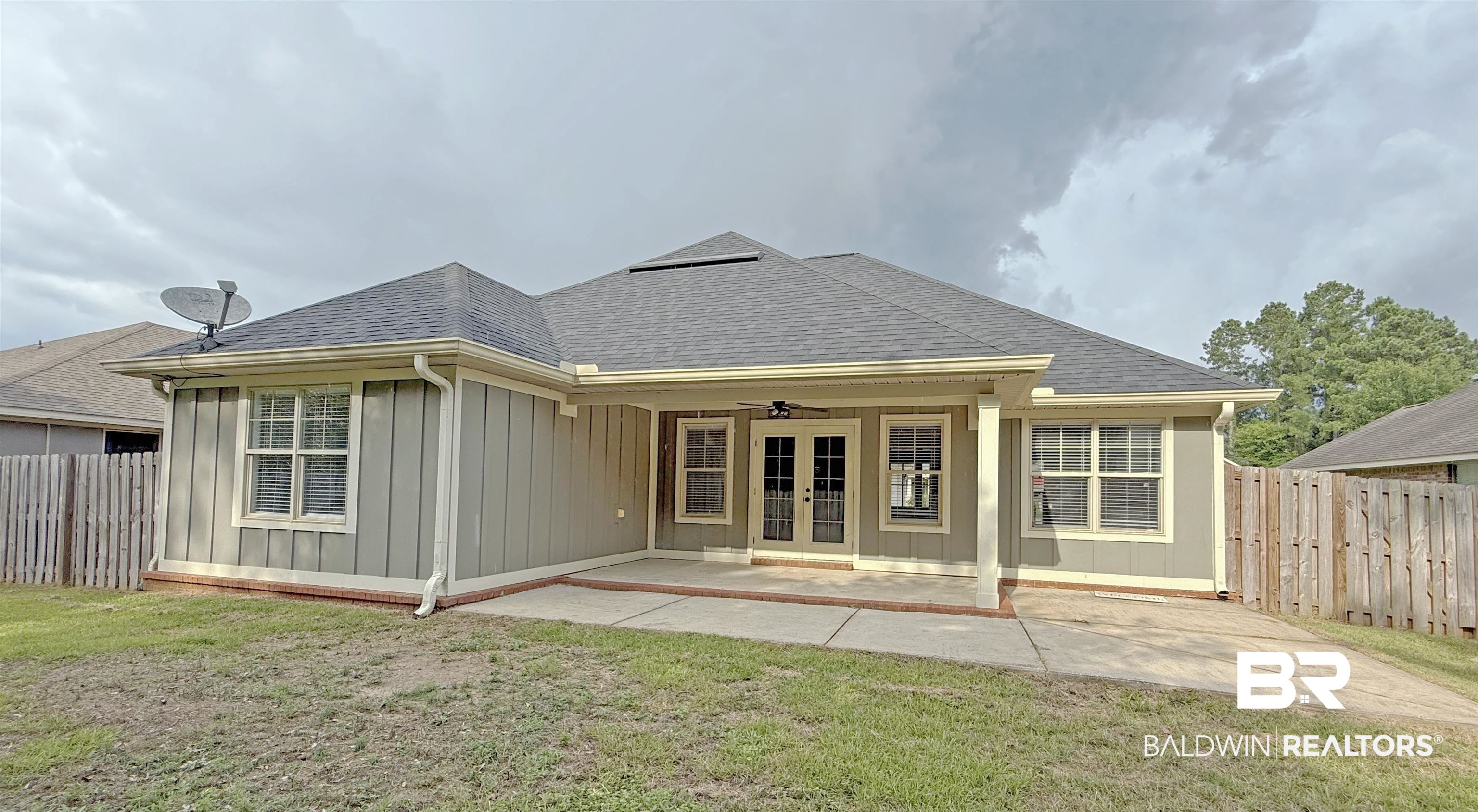 22023 Garland Loop Silverhill, AL 36576 - Photo 30 of 33 Back of property with french doors, board and batten siding, a fenced backyard, and a shingled roof