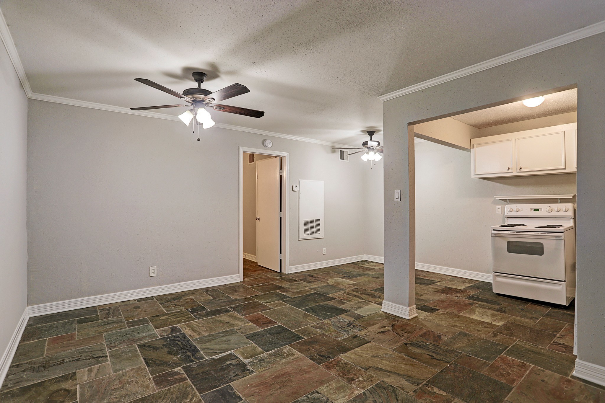 405 Hawthorne Street, Unit 13 Houston, TX 77006 - Photo 4 of 8 a view of a kitchen with a stove and a cabinet