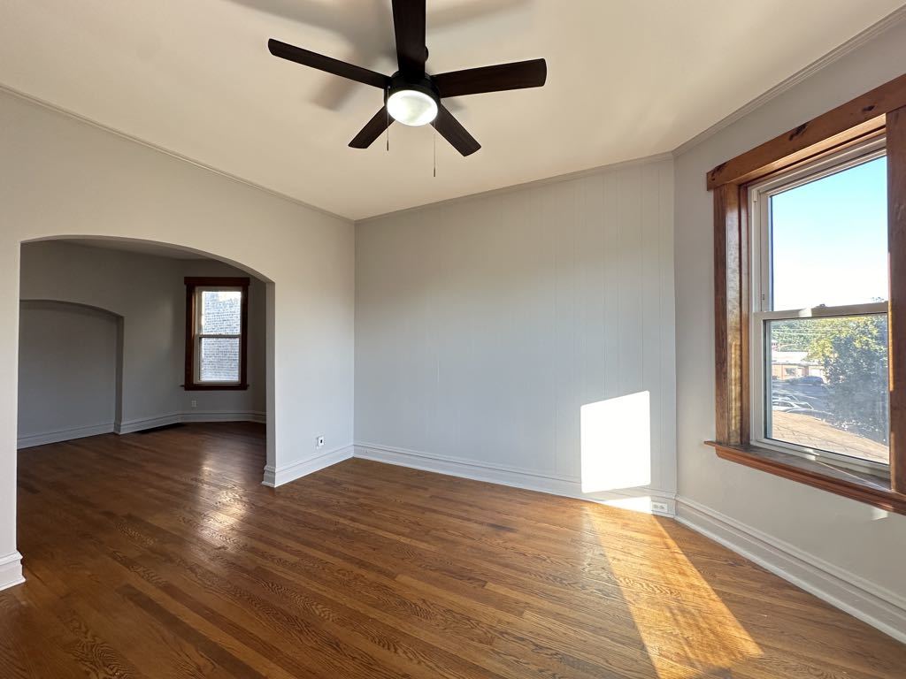 4020 West Cornelia Avenue, Unit 2 Chicago, IL 60641 - Photo 11 of 20 wooden floor in an empty room with a window