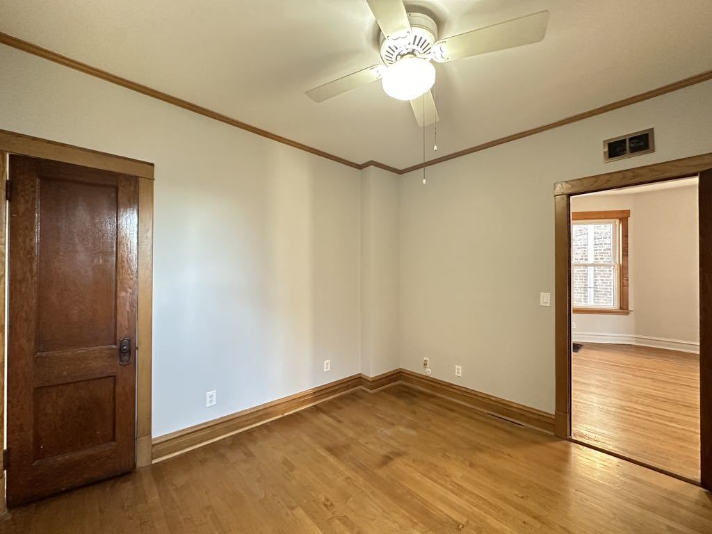4020 West Cornelia Avenue, Unit 2 Chicago, IL 60641 - Photo 16 of 20 an empty room with wooden floor closet and windows