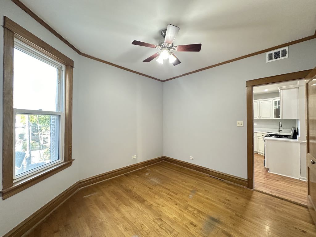 4020 West Cornelia Avenue, Unit 2 Chicago, IL 60641 - Photo 18 of 20 a view of an empty room with window and wooden floor