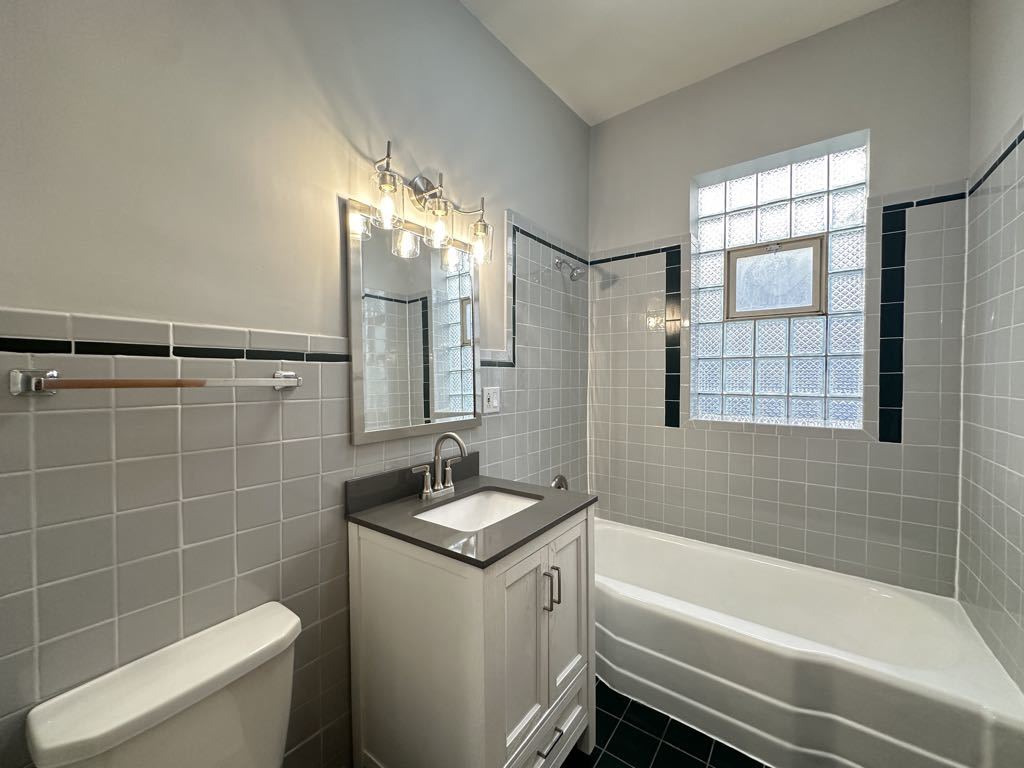 4020 West Cornelia Avenue, Unit 2 Chicago, IL 60641 - Photo 19 of 20 a bathroom with a sink a toilet a tub and shower