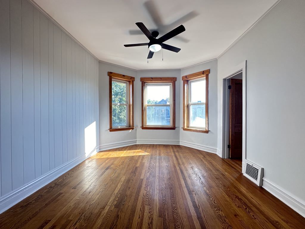 4020 West Cornelia Avenue, Unit 2 Chicago, IL 60641 - Photo 9 of 20 a view of empty room with wooden floor and fan