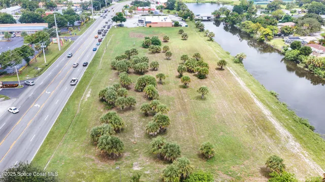 a view of a swimming pool with a flower garden