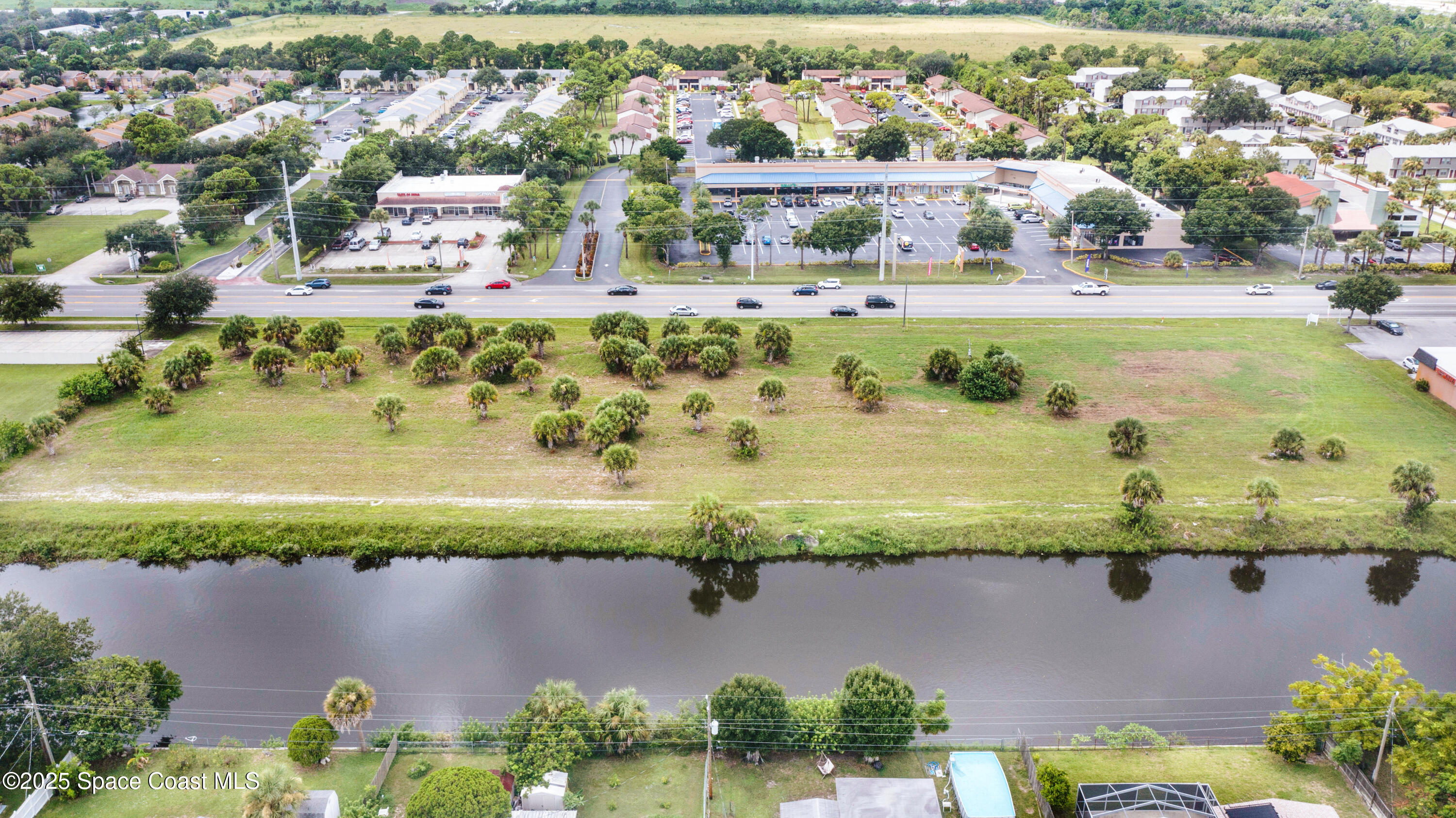 551 North Wickham Road Melbourne, FL 32935 - Photo 6 of 10 an aerial view of a residential houses with outdoor space