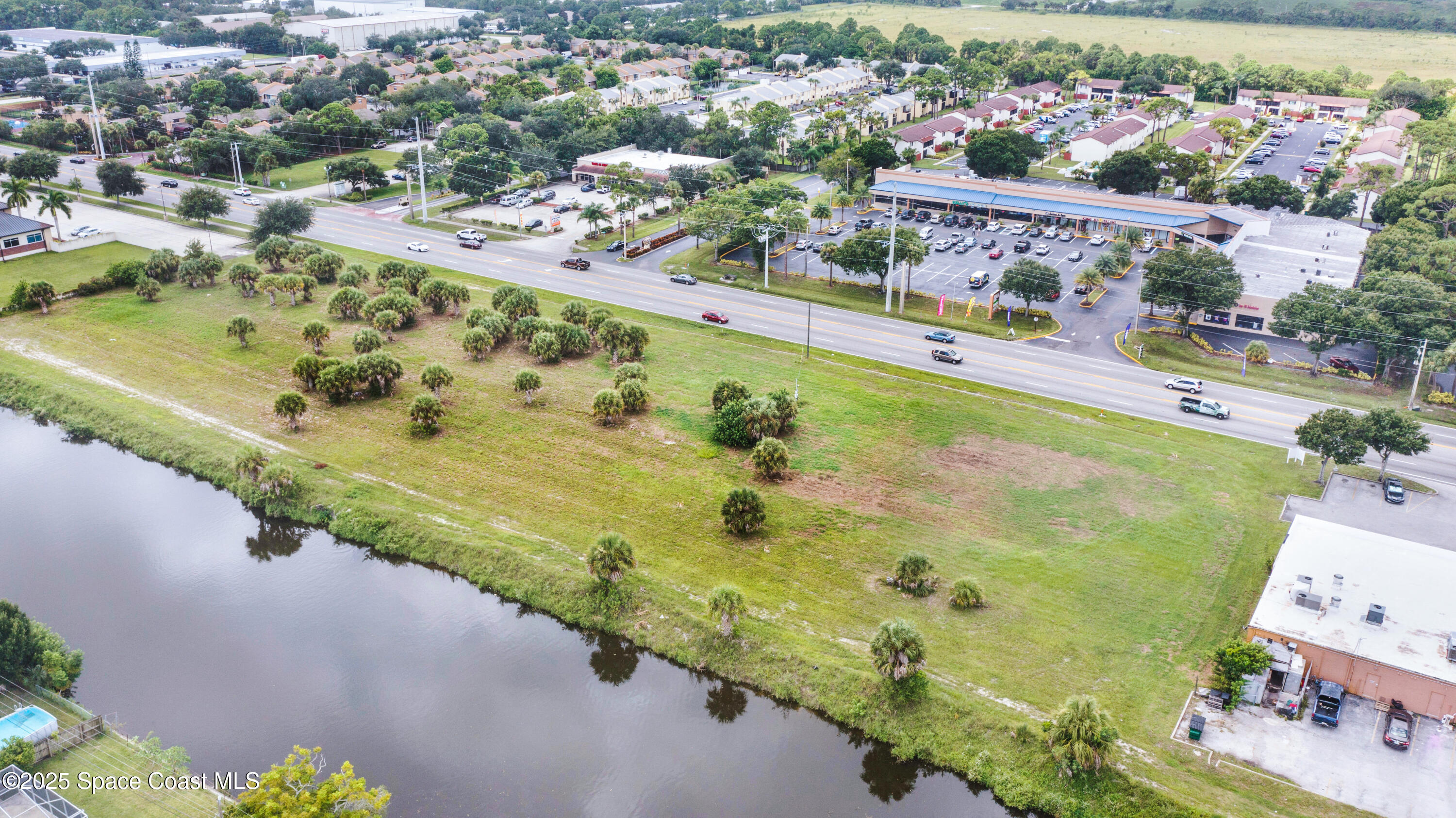 551 North Wickham Road Melbourne, FL 32935 - Photo 7 of 10 an aerial view of swimming pool with a yard