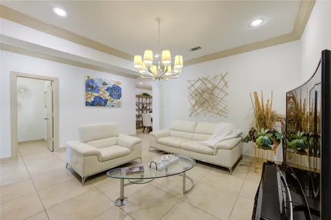 a living room with furniture a chandelier and a chandelier