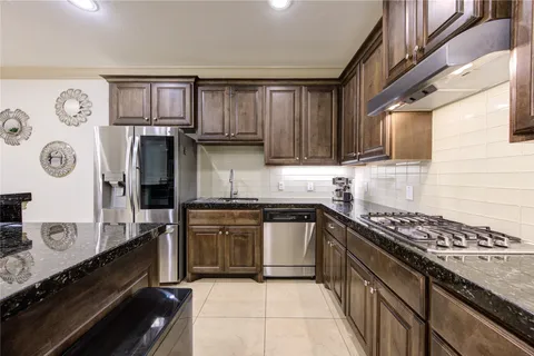 a hallway with wooden floors and couches