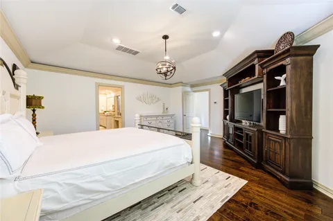a bed room with a bed mirror and a window
