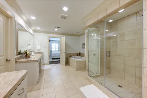 a large bathroom with a granite countertop sink a toilet a mirror and shower