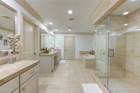 a bathroom with a tub shower and sink