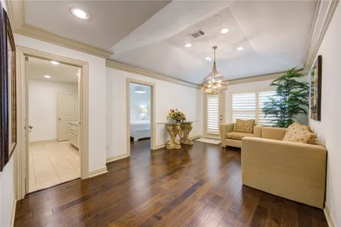 a living room with furniture and a chandelier