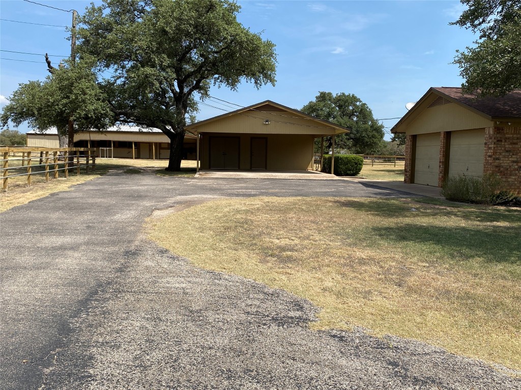 140 Oak Ridge Road Georgetown, TX 78628 - Photo 2 of 40 a front view of a house with a garden