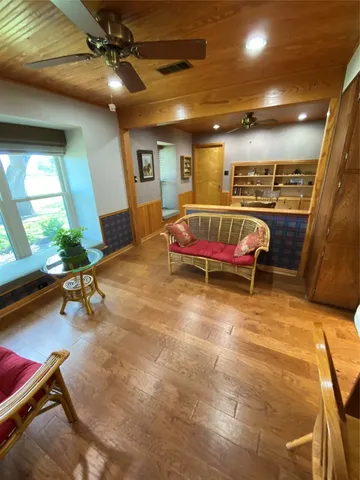 a living room with furniture pool table and a fireplace