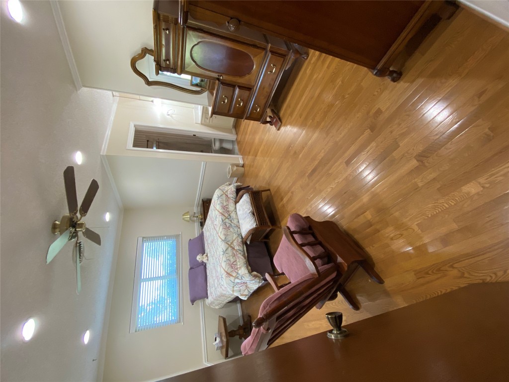 140 Oak Ridge Road Georgetown, TX 78628 - Photo 33 of 40 a bedroom with a bed and a chandelier