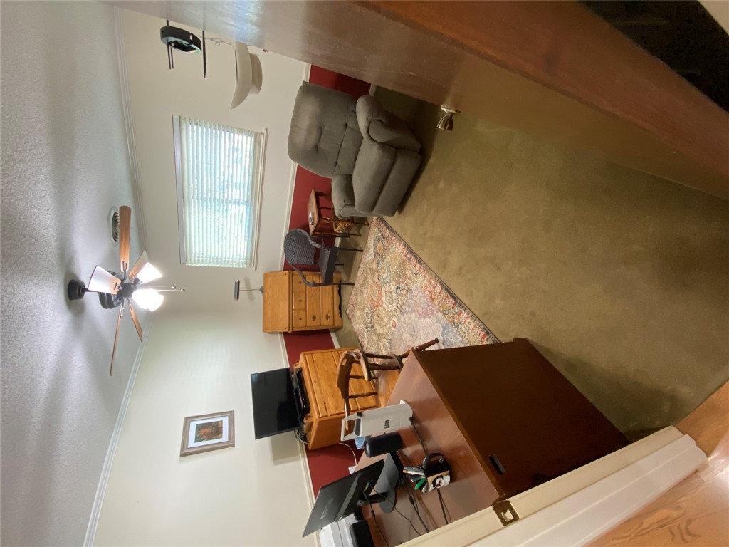 140 Oak Ridge Road Georgetown, TX 78628 - Photo 36 of 40 a living room with furniture and a chandelier