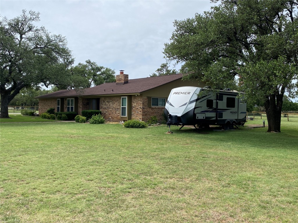 140 Oak Ridge Road Georgetown, TX 78628 - Photo 7 of 40 a front view of a house with a garden and trees