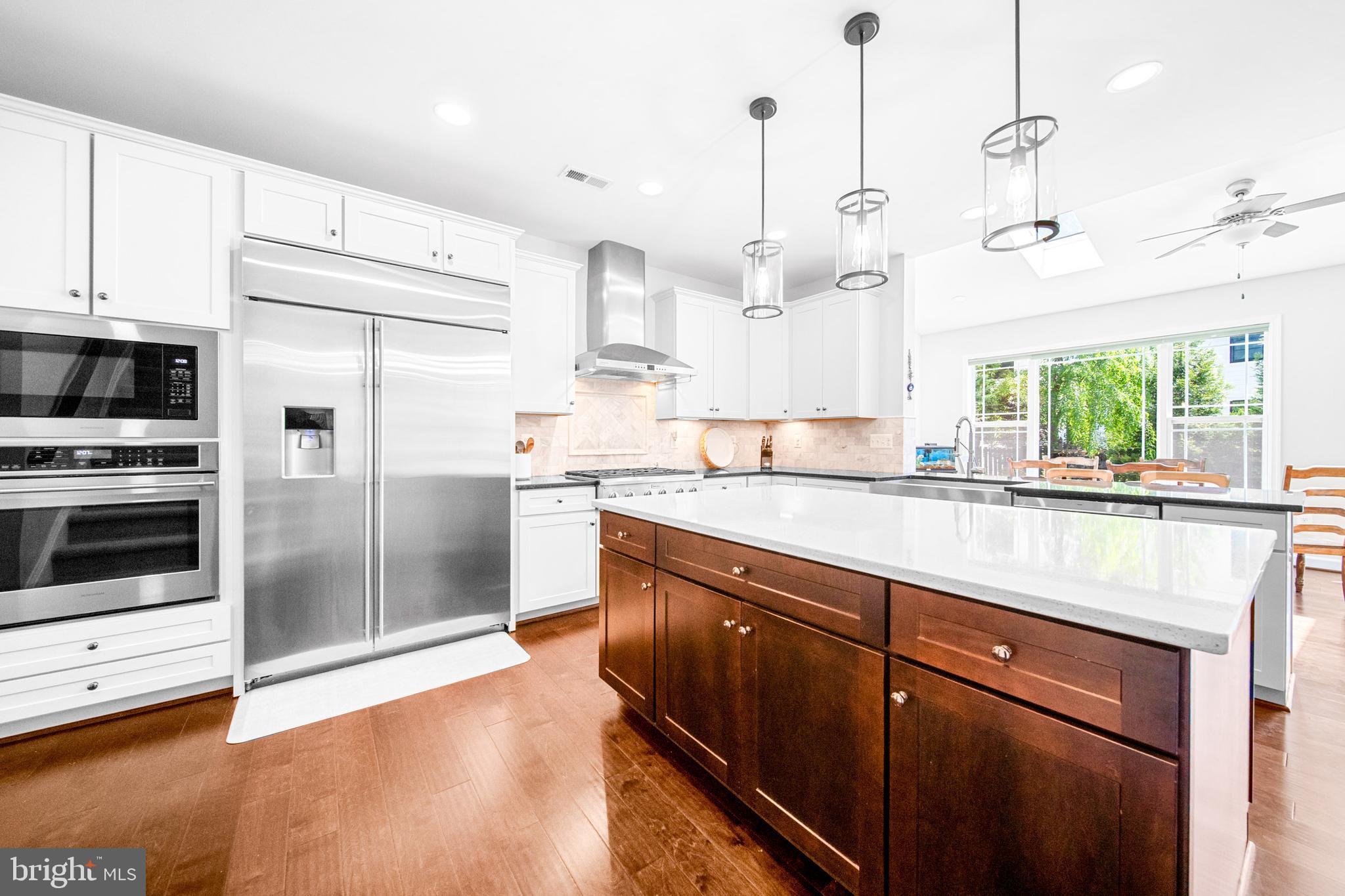 1639 Macon Street McLean, VA 22101 - Photo 18 of 86 a kitchen with stainless steel appliances kitchen island granite countertop a sink a counter space and cabinets