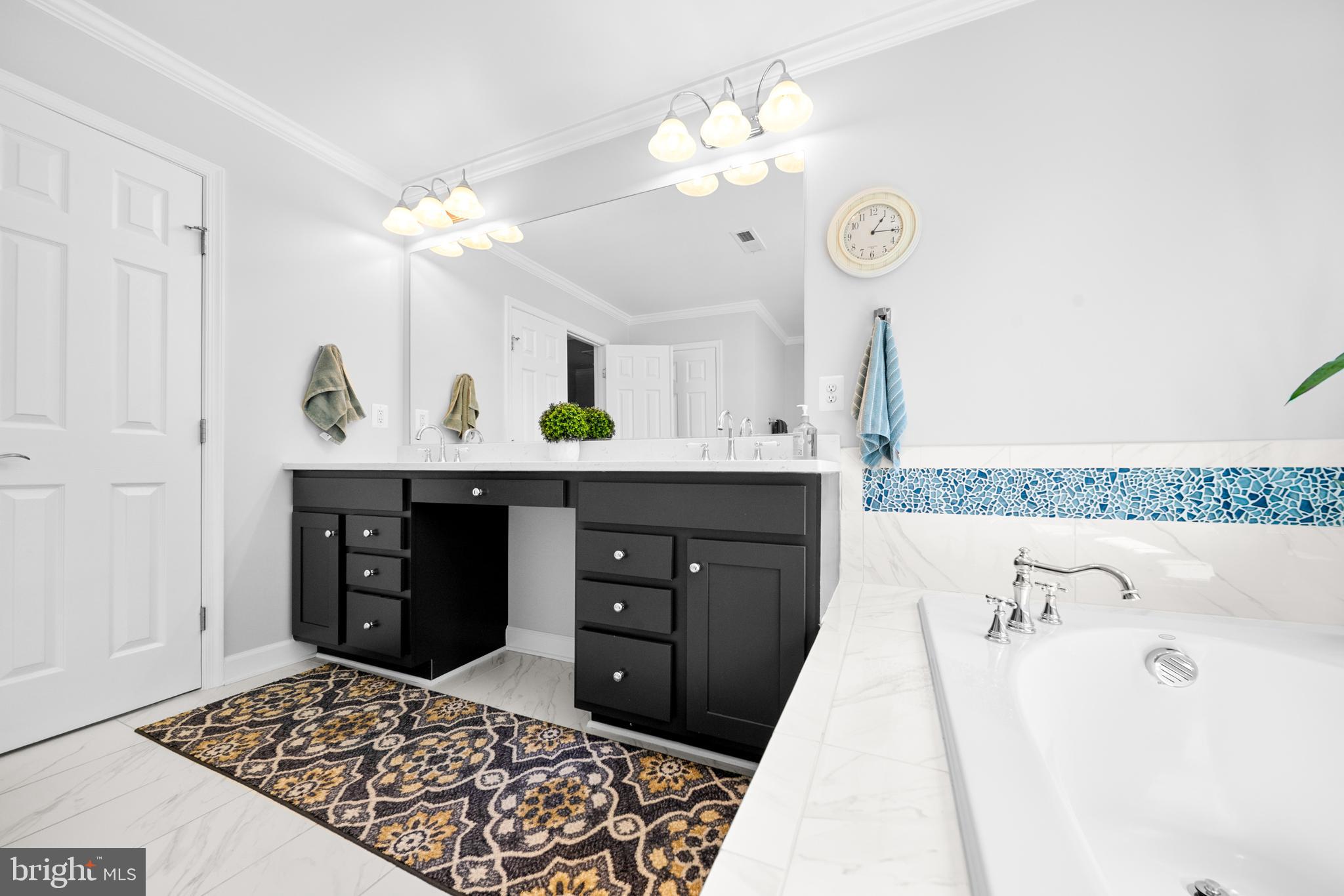 1639 Macon Street McLean, VA 22101 - Photo 45 of 86 a spacious bathroom with a granite countertop sink and a mirror