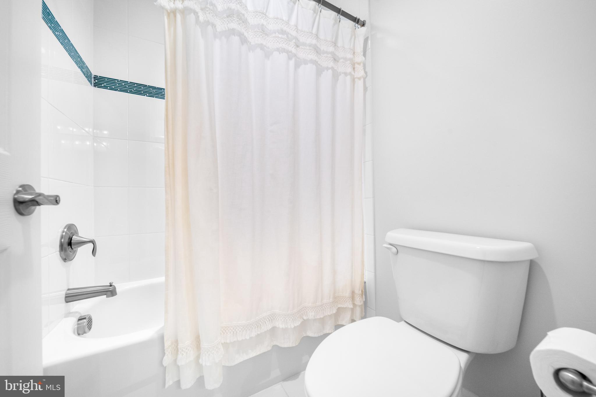 1639 Macon Street McLean, VA 22101 - Photo 54 of 86 a white toilet sitting next to a bathroom sink