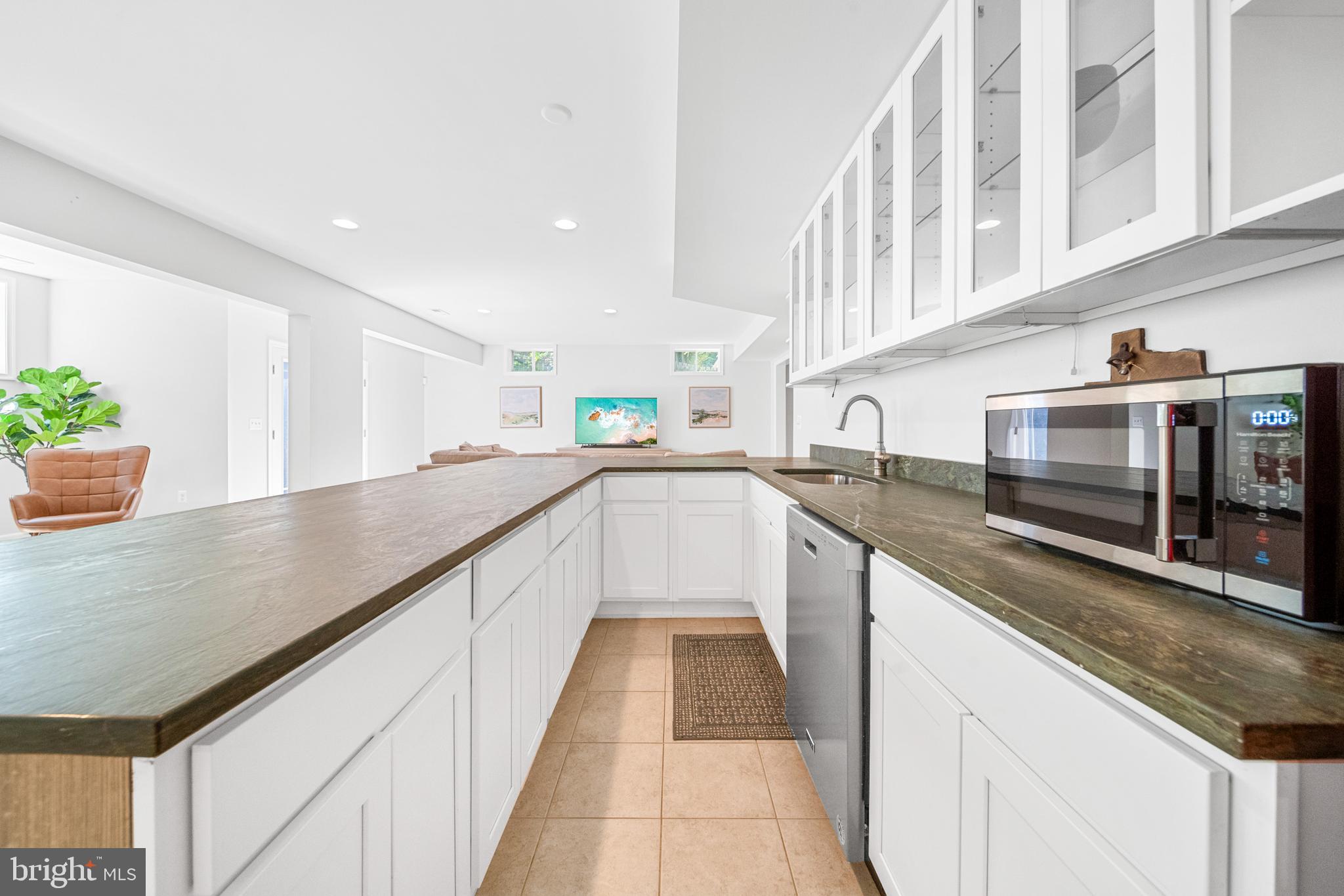 1639 Macon Street McLean, VA 22101 - Photo 70 of 86 a kitchen with stainless steel appliances granite countertop a sink and dishwasher a stove with wooden floor