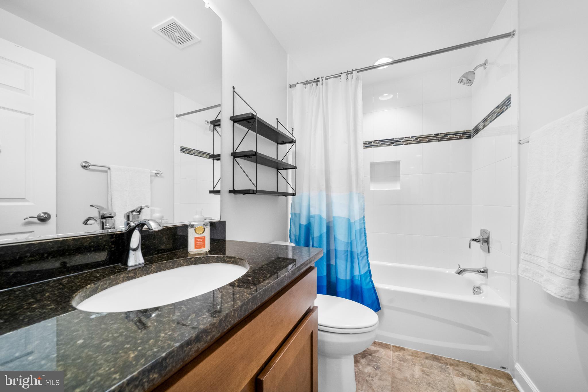1639 Macon Street McLean, VA 22101 - Photo 75 of 86 a bathroom with a granite countertop sink and a mirror