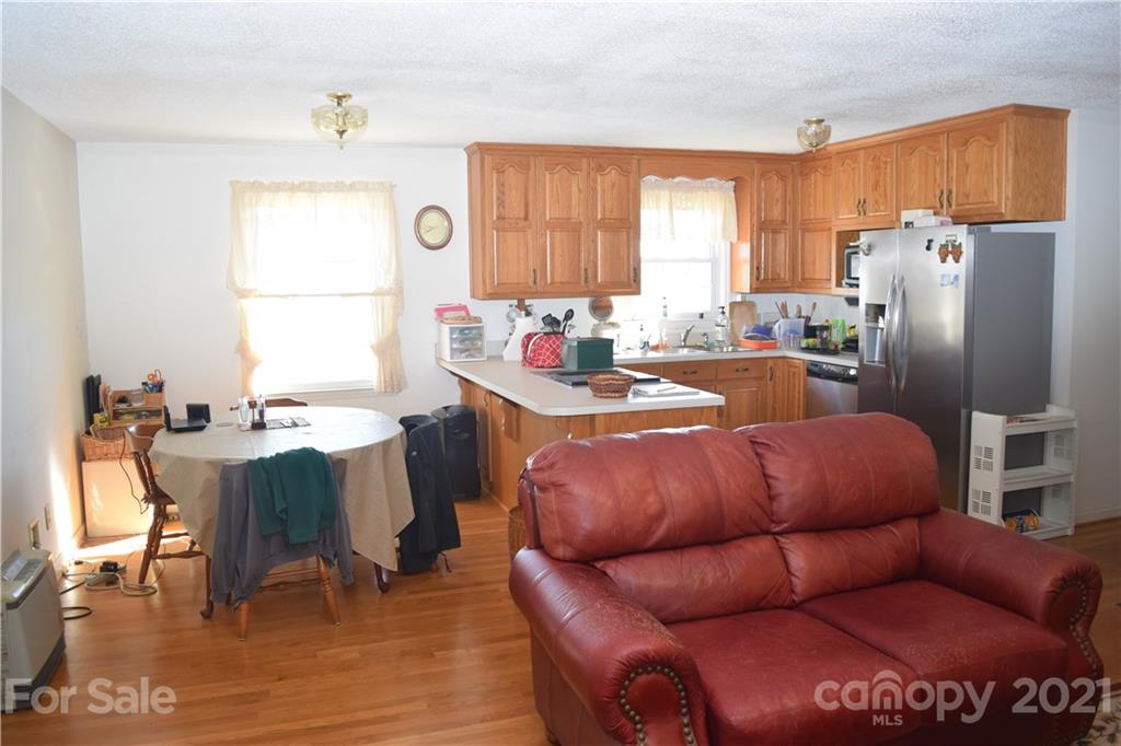 3189 Short Road Hickory, NC 28602 - Photo 18 of 24 a living room with furniture a large window and a refrigerator