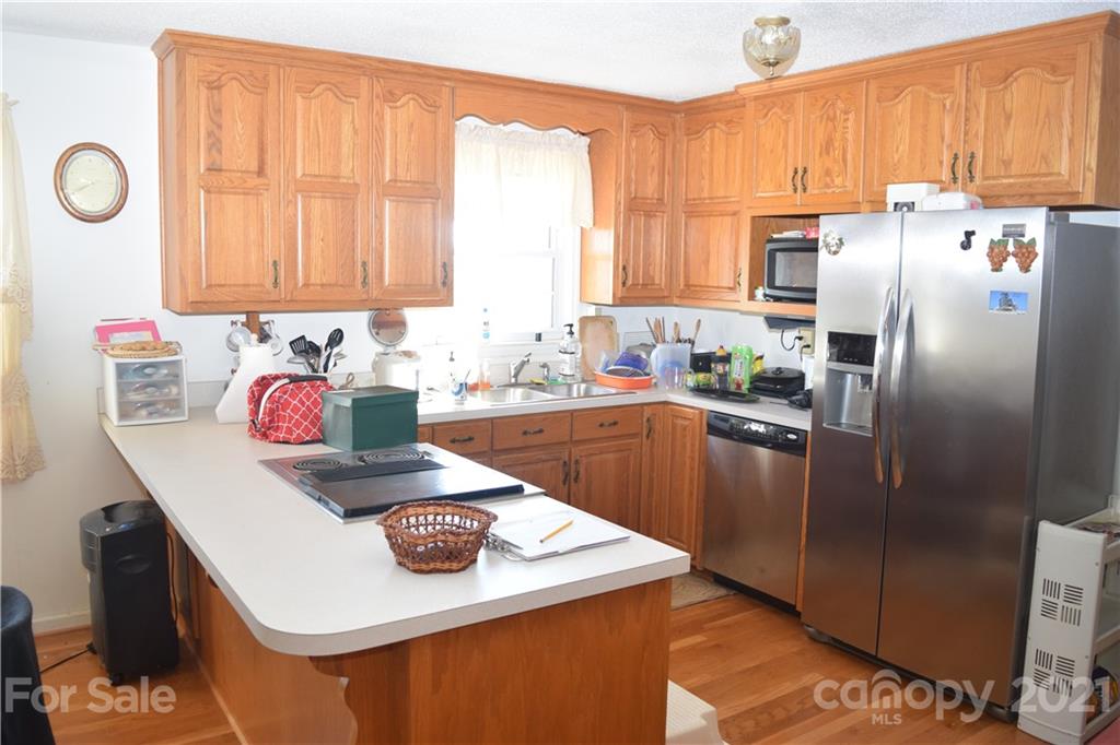 3189 Short Road Hickory, NC 28602 - Photo 20 of 24 a kitchen with stainless steel appliances granite countertop a sink a stove a refrigerator and cabinets