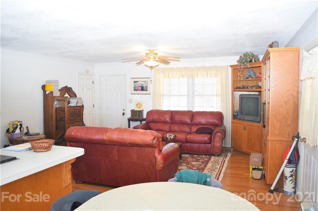 3189 Short Road Hickory, NC 28602 - Photo 21 of 24 a living room with furniture a fireplace and a flat screen tv
