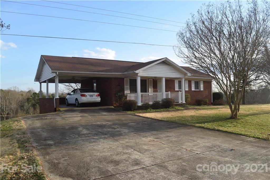 3189 Short Road Hickory, NC 28602 - Photo 7 of 24 a front view of a house with a garden and trees