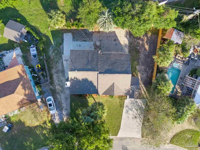 an aerial view of a house with a yard