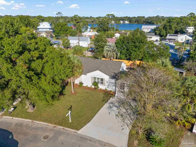 an aerial view of a house with a yard basket ball court and outdoor seating