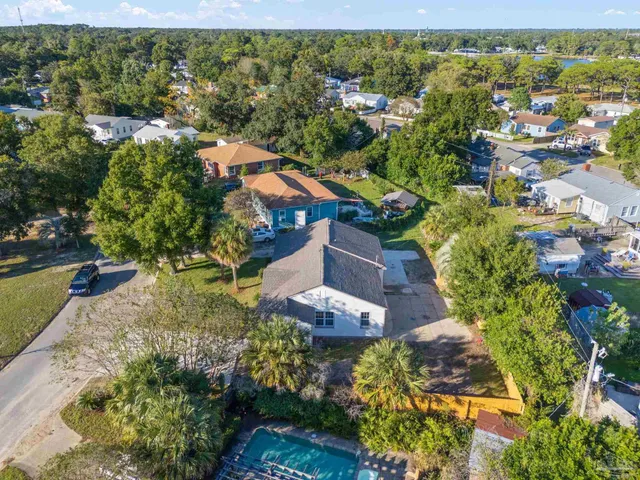 an aerial view of residential houses with outdoor space and street view