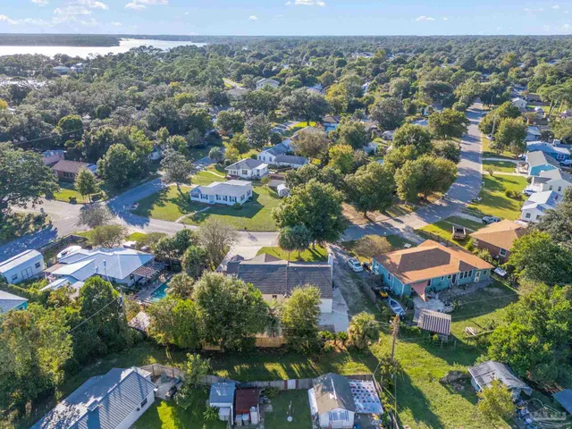 an aerial view of residential houses with outdoor space and river