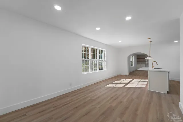 a kitchen with kitchen island a sink a counter top space and stainless steel appliances