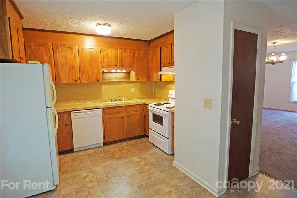 4887 County Home Road, Unit G2 Conover, NC 28613 - Photo 2 of 8 a kitchen with a sink a stove and refrigerator