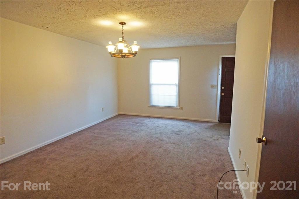 4887 County Home Road, Unit G2 Conover, NC 28613 - Photo 5 of 8 an empty room with a chandelier