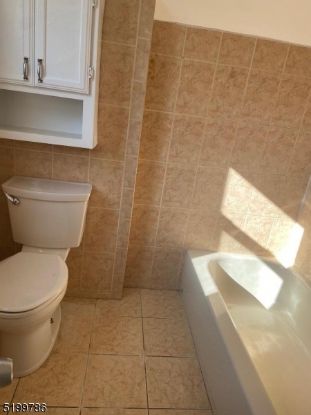 33 Ryerson Avenue, Unit 2 Paterson, NJ 07502 - Photo 5 of 6 a bathroom with a toilet and a shower