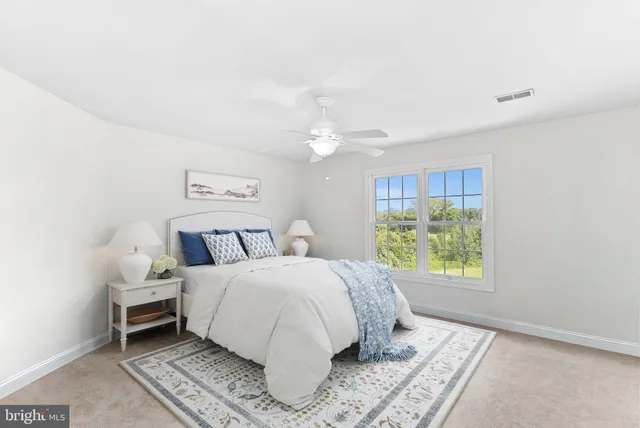a bed sitting in a bedroom next to a window